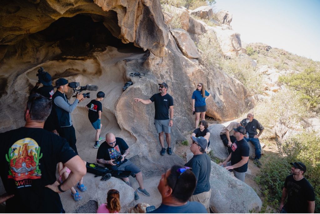 raptor run attendees listening to the history of a cave